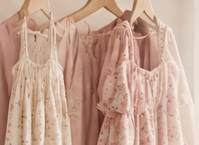 Soft pink and cream dresses on hangers